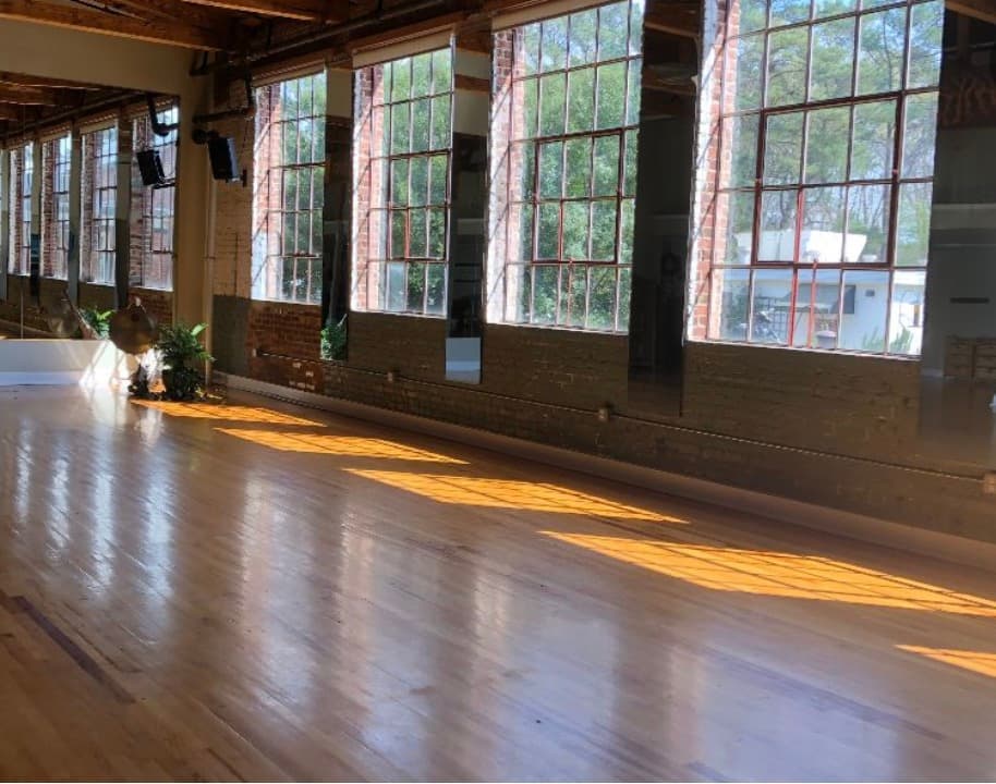 Historic Chatham Mills studio space with exposed brick walls and wood floors